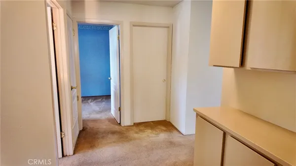 a view of storage and utility room with wooden floor