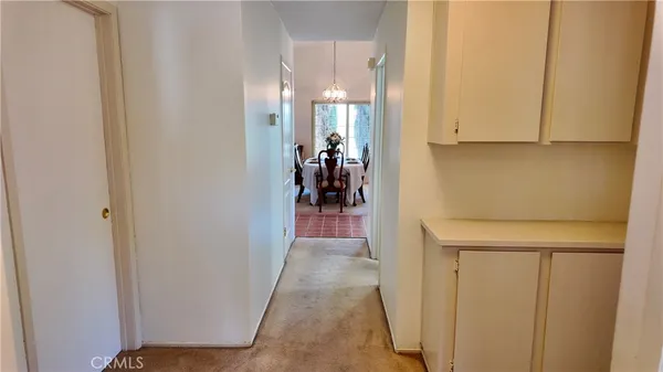 a view of a hallway with wooden shelves