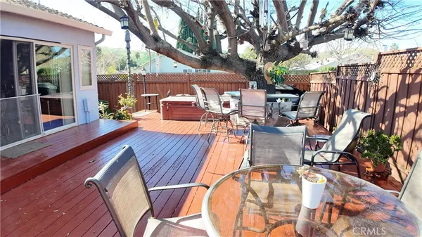 a view of a patio with table and chairs next to a yard