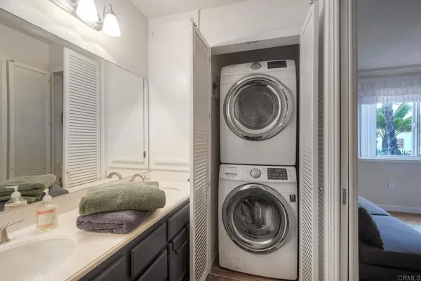 a utility room with sink dryer and washer