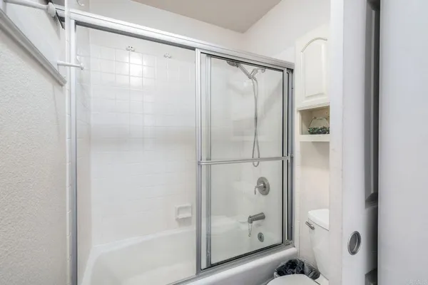 a bathroom with a glass shower door