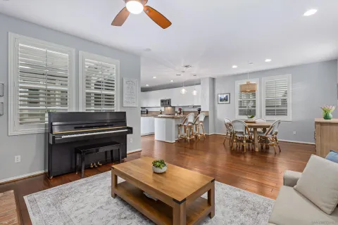 a living room with furniture a dining table and chairs with kitchen view