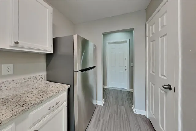a kitchen with a refrigerator and cabinets