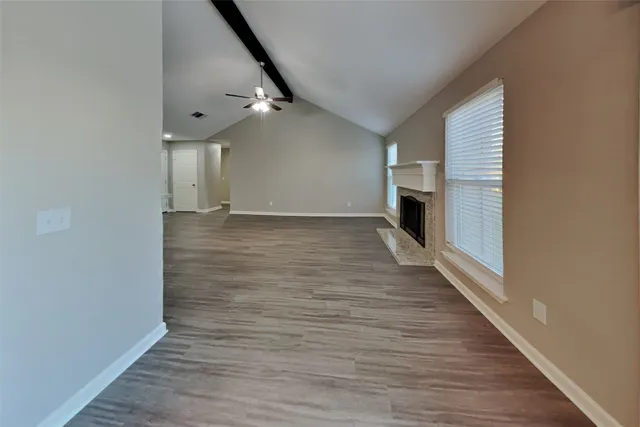 a view of a livingroom with wooden floor and staircase