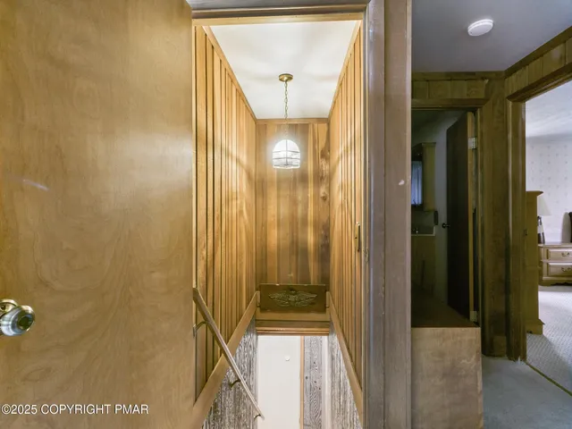 a view of a hallway with wooden floor and glass door
