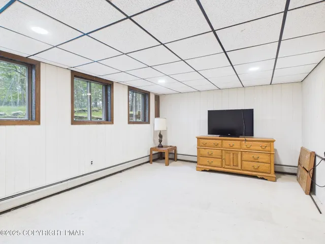 a bedroom with furniture and flat screen tv