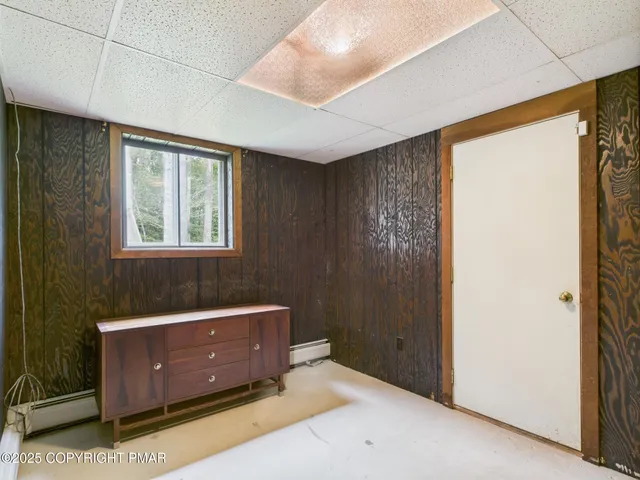 a living room with a bed and a window