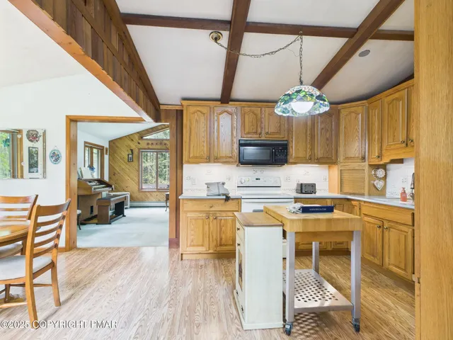 a kitchen with stainless steel appliances granite countertop a refrigerator a stove top oven a sink and dishwasher