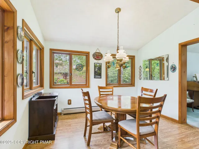 a kitchen that has a lot of cabinets in it and wooden floor