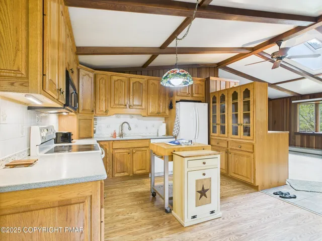 a living room with furniture pool table and a large window