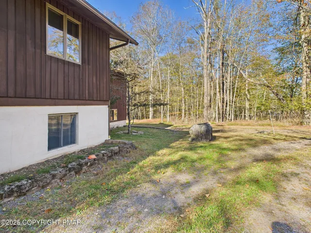 a backyard of a building with large trees