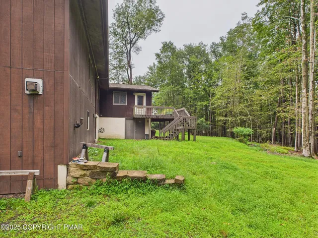 a view of a backyard with table and chairs and potted plants