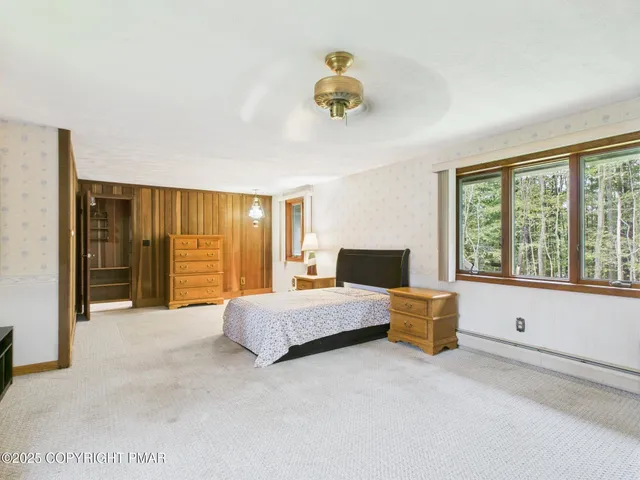 a spacious bedroom with a bed and a large window