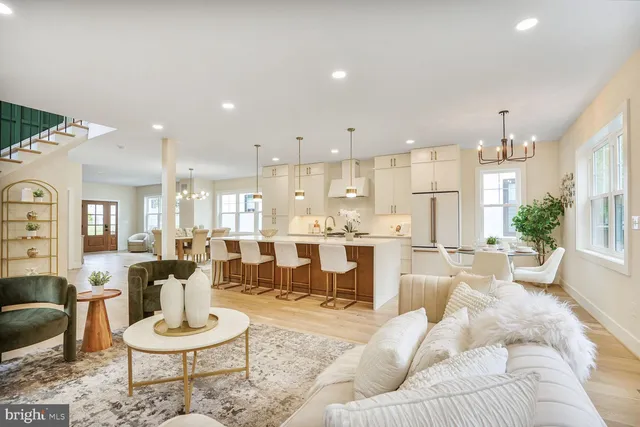 a living room with furniture and a dining table with kitchen view