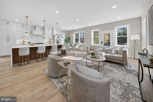a living room with furniture and kitchen view