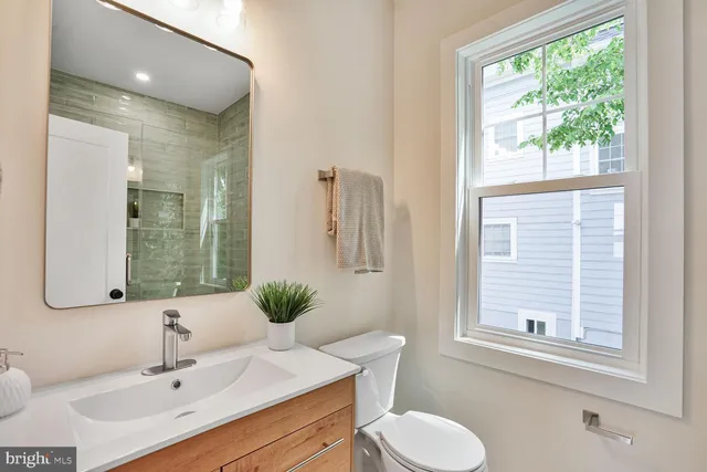 a bathroom with a toilet sink and mirror