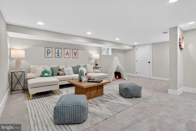 a living room with furniture a window and a table