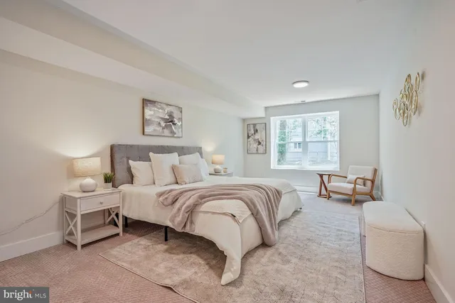 a spacious bedroom with a bed and a couch