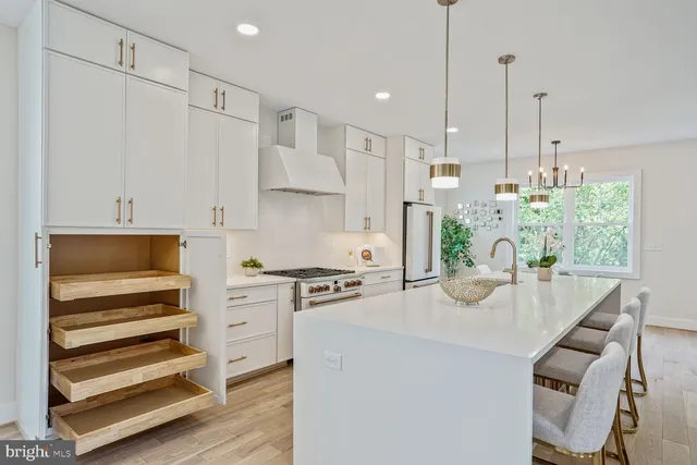 a kitchen with kitchen island a stove cabinets and wooden floor