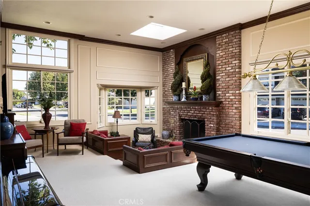a living room with furniture fireplace and window