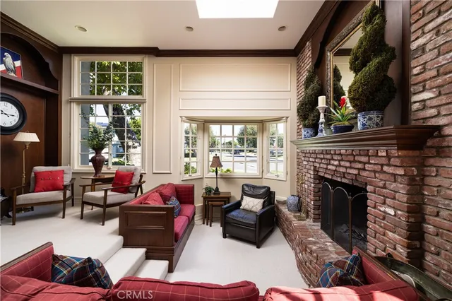 a living room with furniture mirror and fireplace
