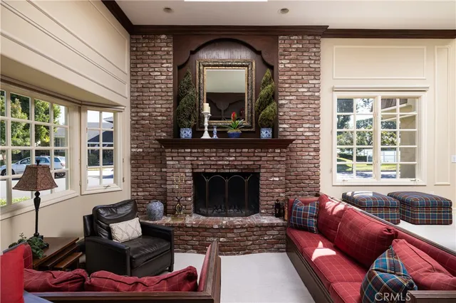 a living room with furniture a fireplace and a window