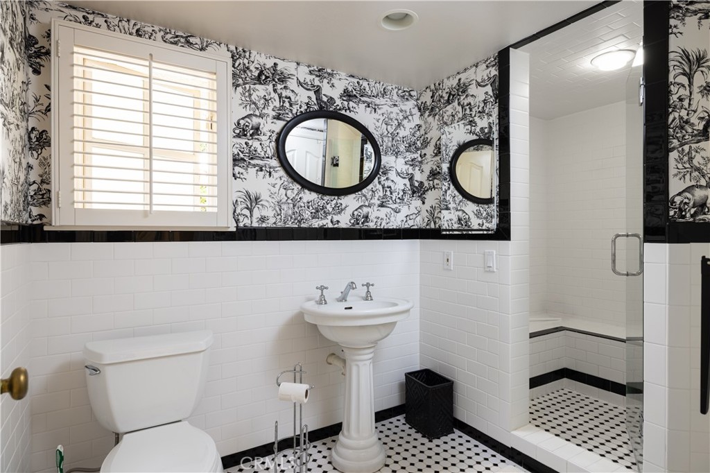 1901 Windward Lane Newport Beach, CA 92660 - Photo 20 of 52 a bathroom with a toilet a sink and a mirror