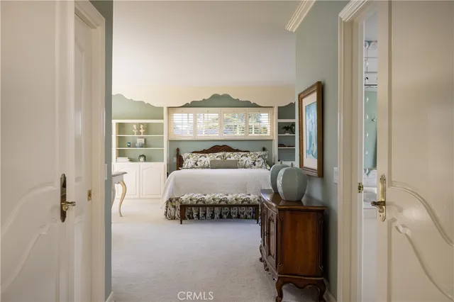 a bedroom with a large bed and a large window