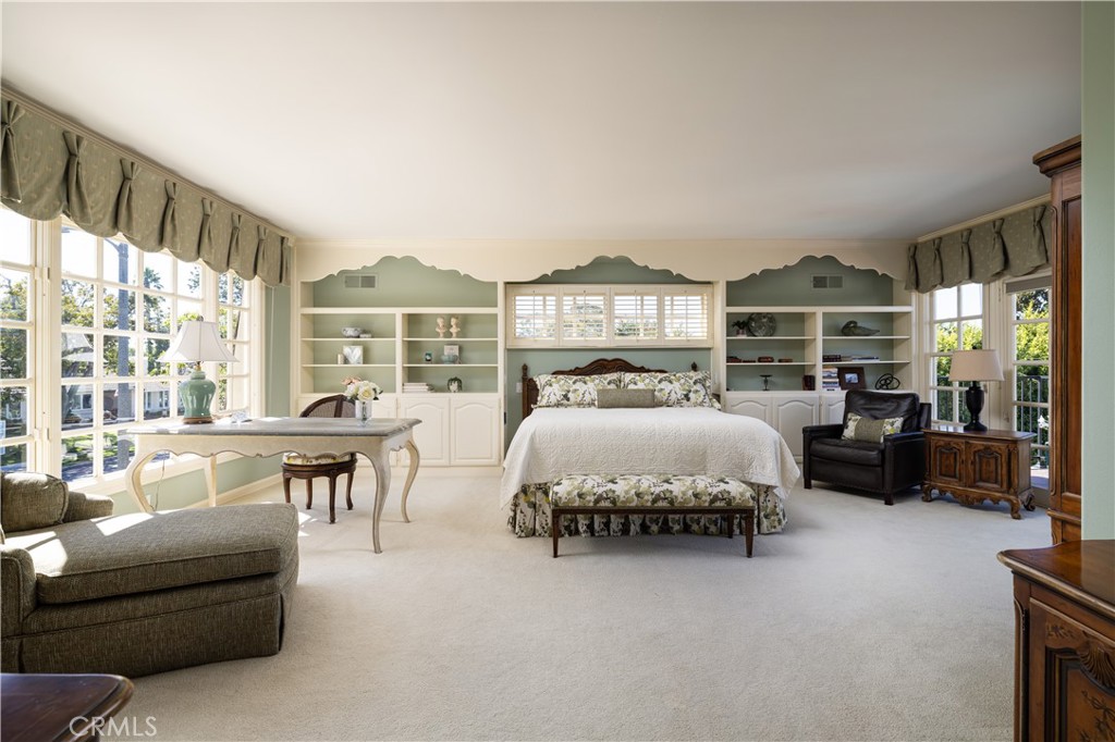 1901 Windward Lane Newport Beach, CA 92660 - Photo 24 of 52 a spacious bedroom with a bed a table and large windows
