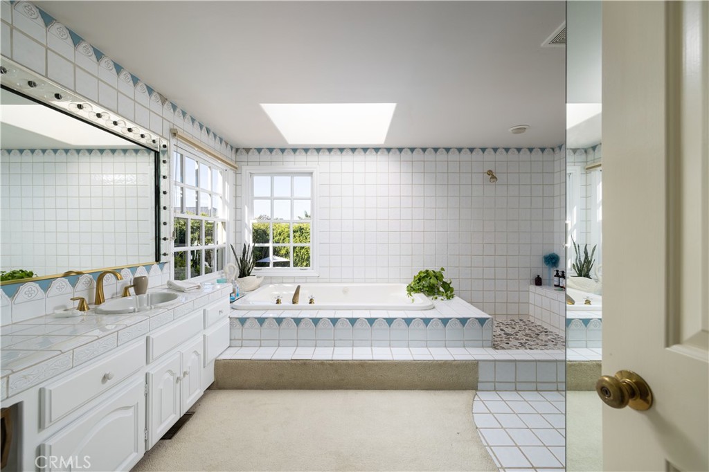 1901 Windward Lane Newport Beach, CA 92660 - Photo 26 of 52 a bathroom with a tub sink and mirror