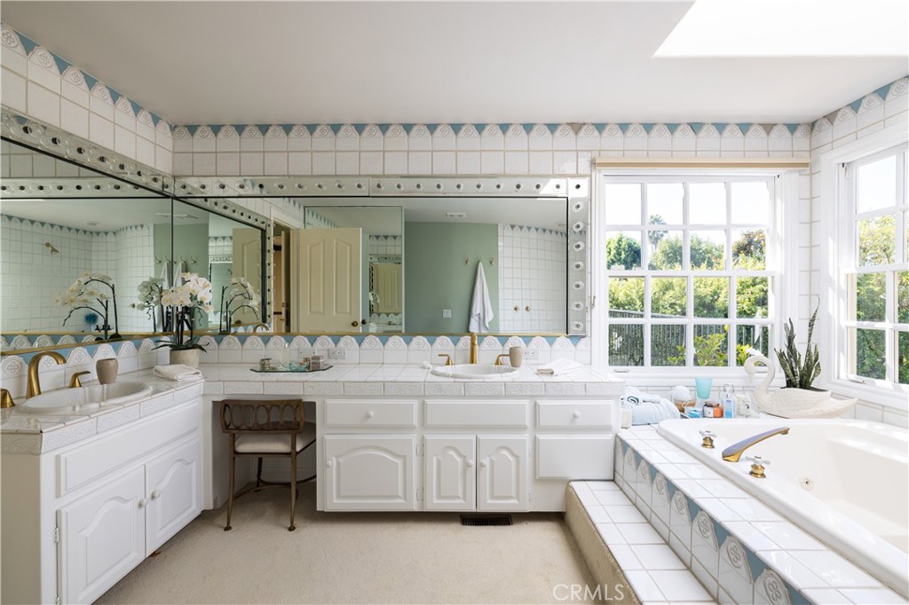 1901 Windward Lane Newport Beach, CA 92660 - Photo 27 of 52 a large bathroom with a double vanity sink large mirror and bathtub