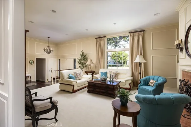 a living room with furniture a window and a clock