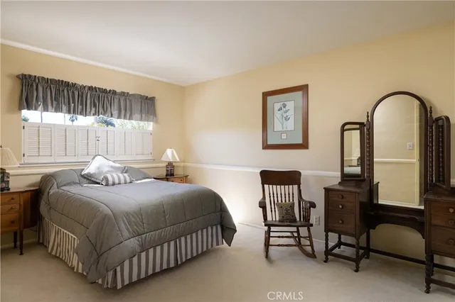 a bedroom with a bed chair and window