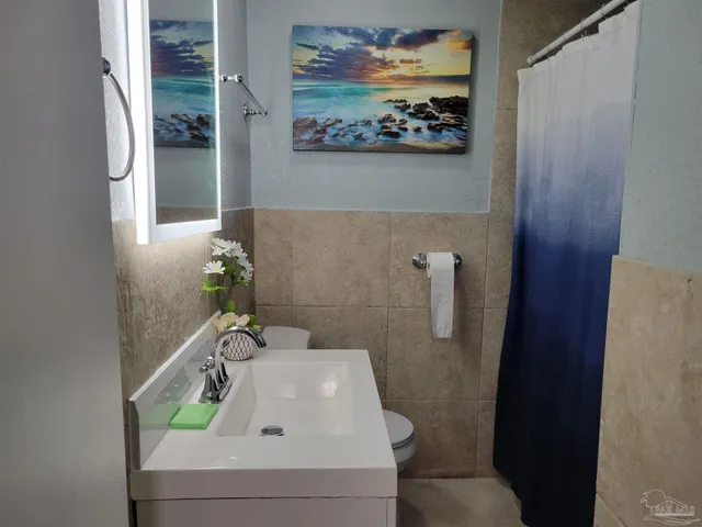 a view of a room with a wooden space and a window