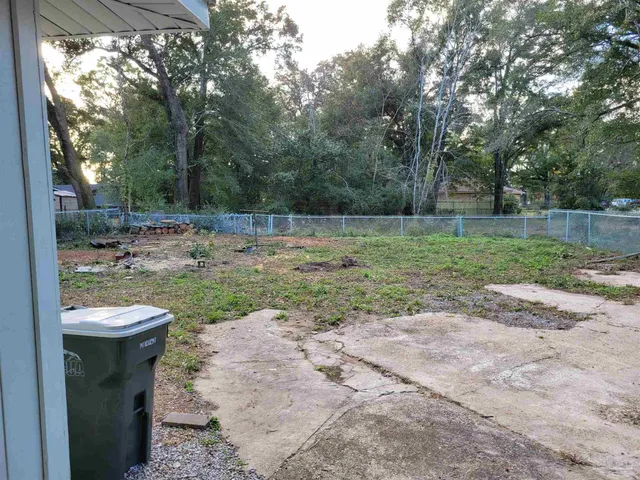 a view of a backyard with trees