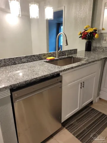 a kitchen with sink and mirror