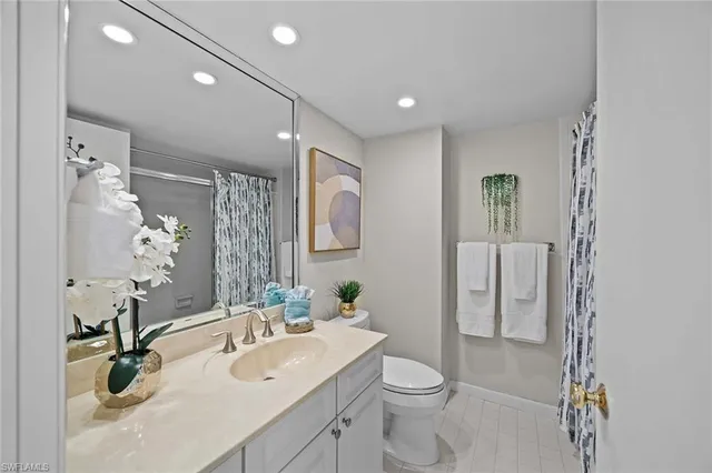 a spacious bathroom with a double vanity sink and a mirror