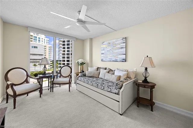 a living room with furniture and a ceiling fan