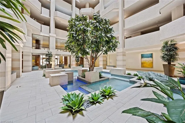 a kitchen with stainless steel appliances granite countertop a sink a stove a refrigerator and cabinets