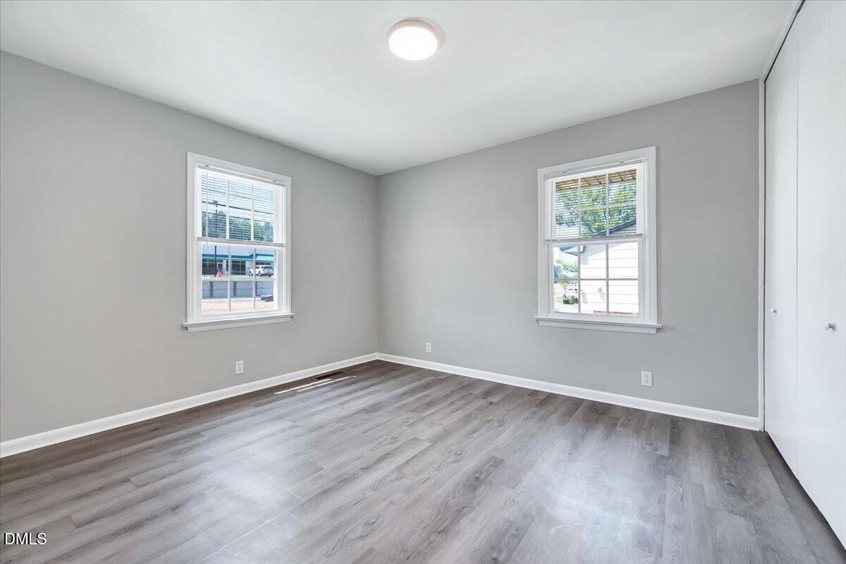 3408 Atlantic Avenue Raleigh, NC 27604 - Photo 43 of 48 an empty room with wooden floor and windows