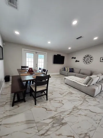 a kitchen with kitchen island granite countertop a sink stainless steel appliances and cabinets