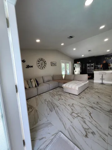 a living room with furniture and a large window