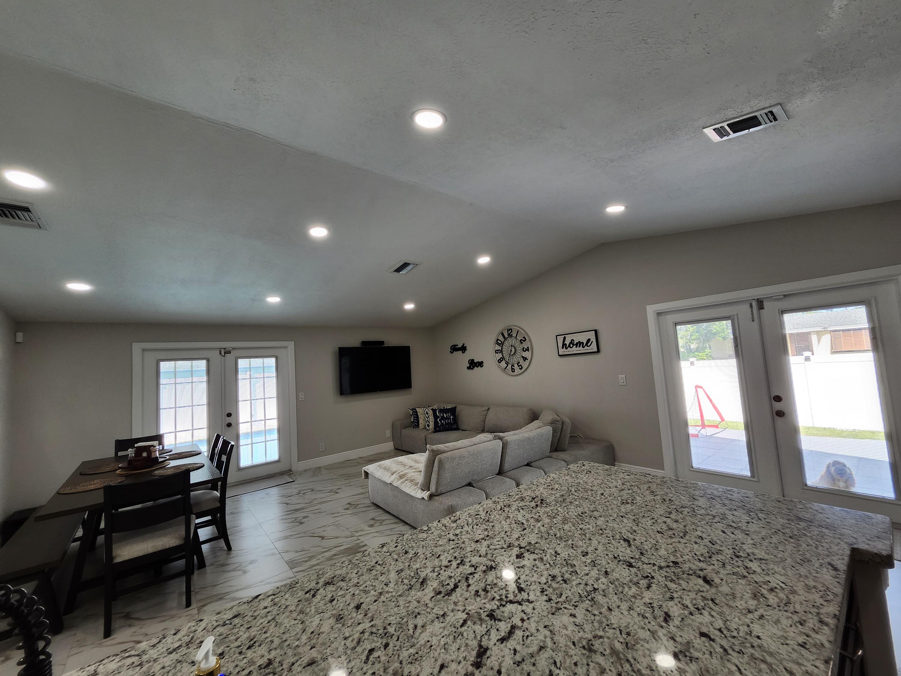 1473 Donwoods Lane Royal Palm Beach, FL 33411 - Photo 18 of 95 a living room with furniture and large windows