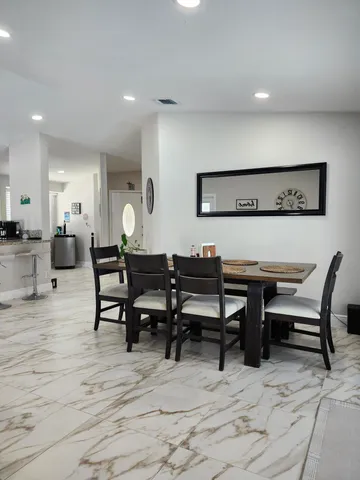 a living room with furniture and a gym machine