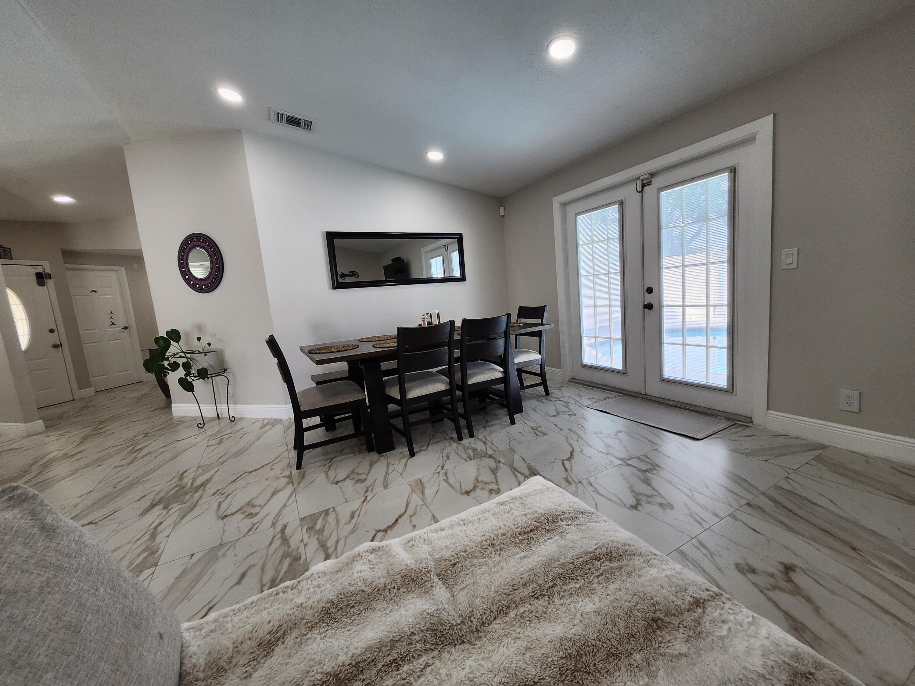 1473 Donwoods Lane Royal Palm Beach, FL 33411 - Photo 26 of 95 a living room with furniture and a large window