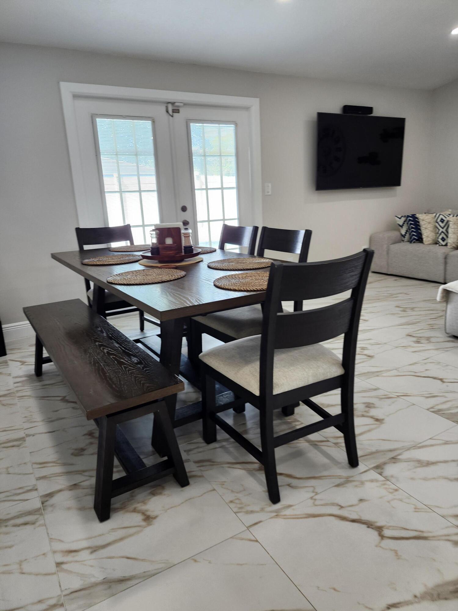 1473 Donwoods Lane Royal Palm Beach, FL 33411 - Photo 27 of 95 a living room with a table a computer and a window