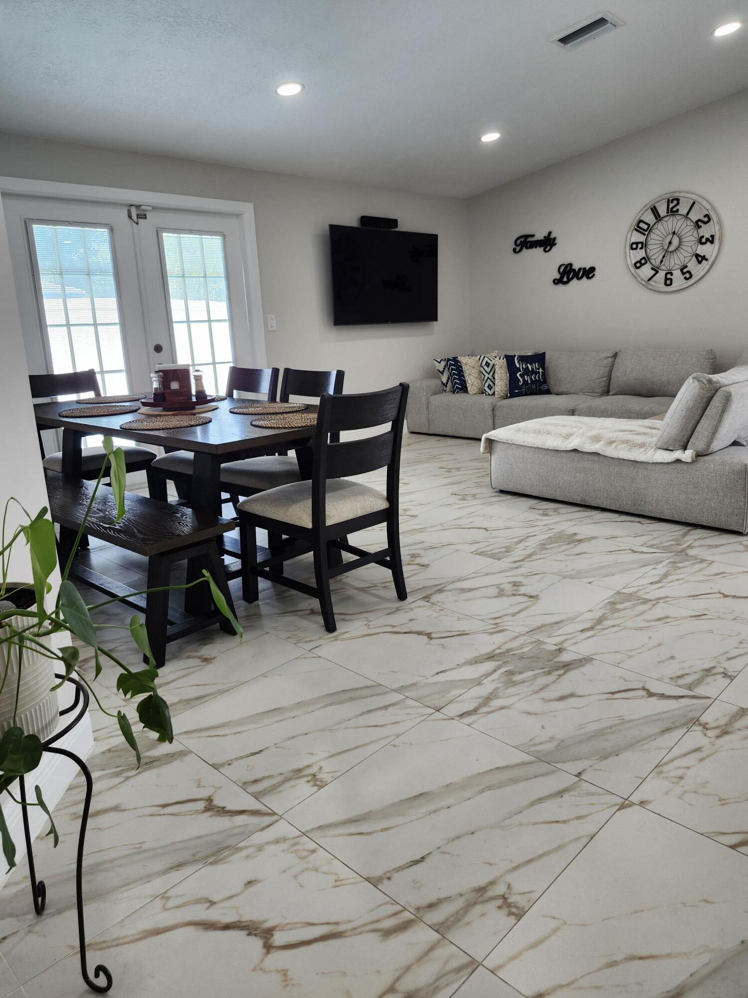 1473 Donwoods Lane Royal Palm Beach, FL 33411 - Photo 28 of 95 a living room with furniture and a flat screen tv