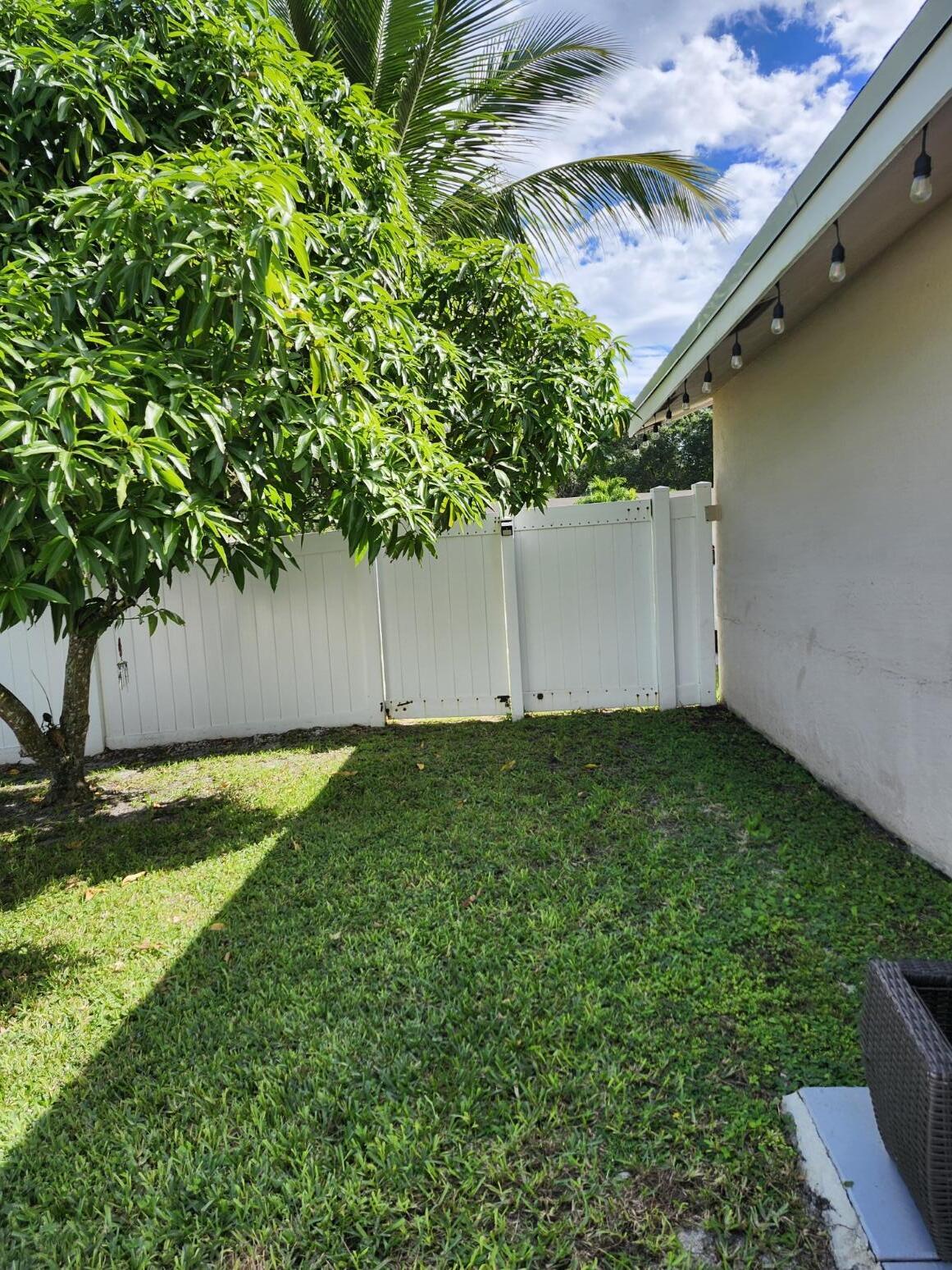 1473 Donwoods Lane Royal Palm Beach, FL 33411 - Photo 30 of 95 a backyard of a house with lots of green space