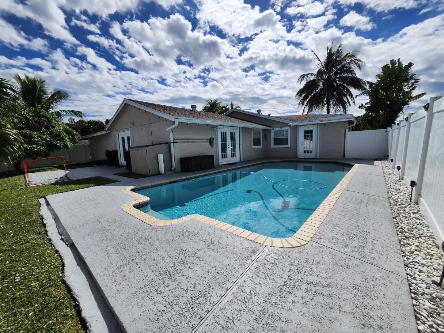 1473 Donwoods Lane Royal Palm Beach, FL 33411 - Photo 36 of 95 a front view of a house with garden