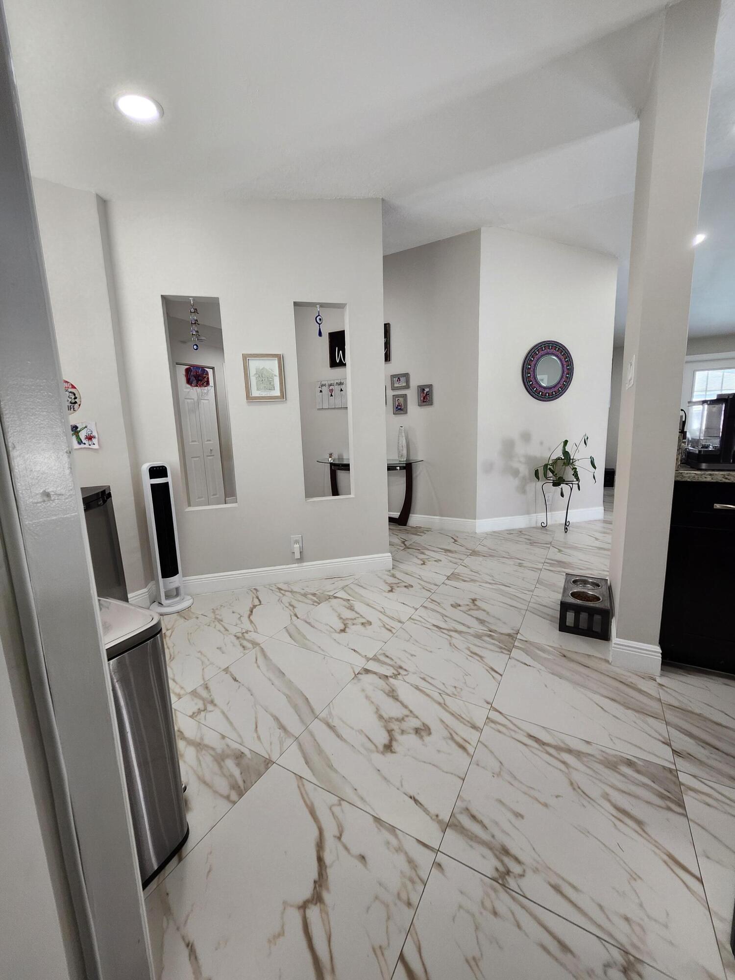 1473 Donwoods Lane Royal Palm Beach, FL 33411 - Photo 42 of 95 a bedroom with a bed mirror and a window